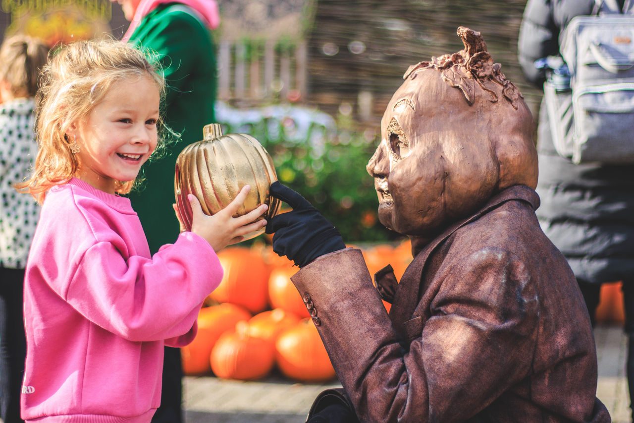 Girl with pumpkin and pumpkin man